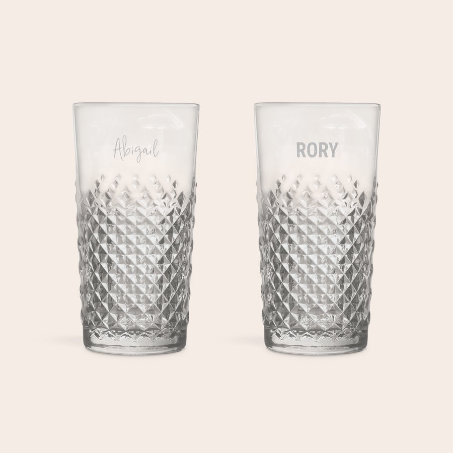 Two personalised engraved mojito glasses with diamond patterns. One glass is engraved with "Abigail" and the other with "RORY".