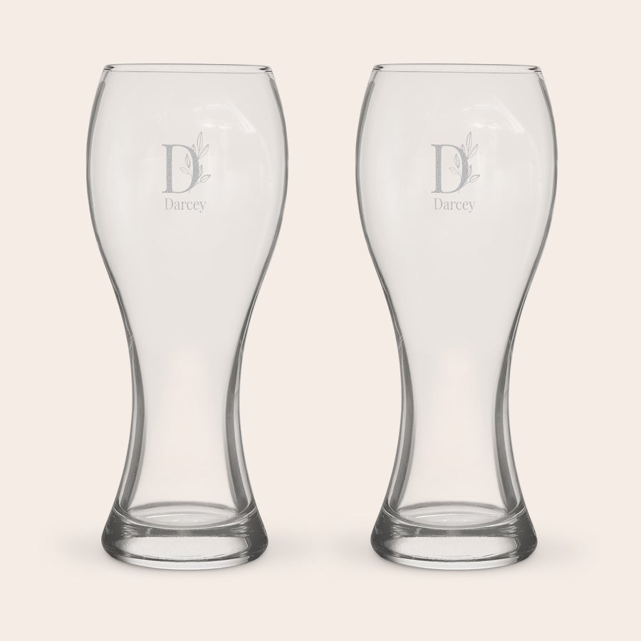 Two personalized XL beer glasses, each engraved with a decorative D and the name Darcy.
