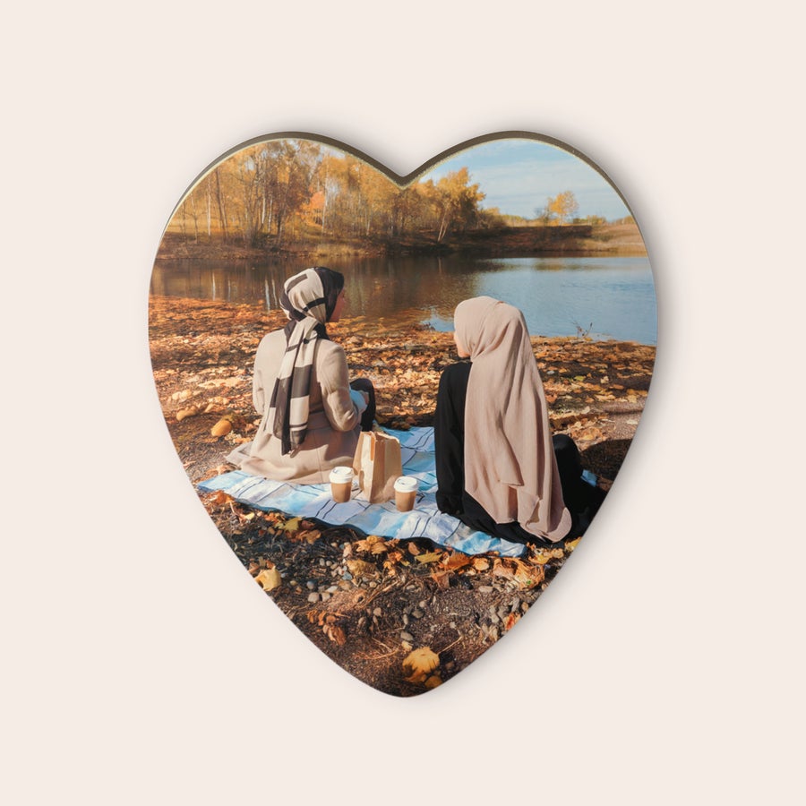 Personalized chocolate heart with a printed photo of two women having a picnic by a lake.