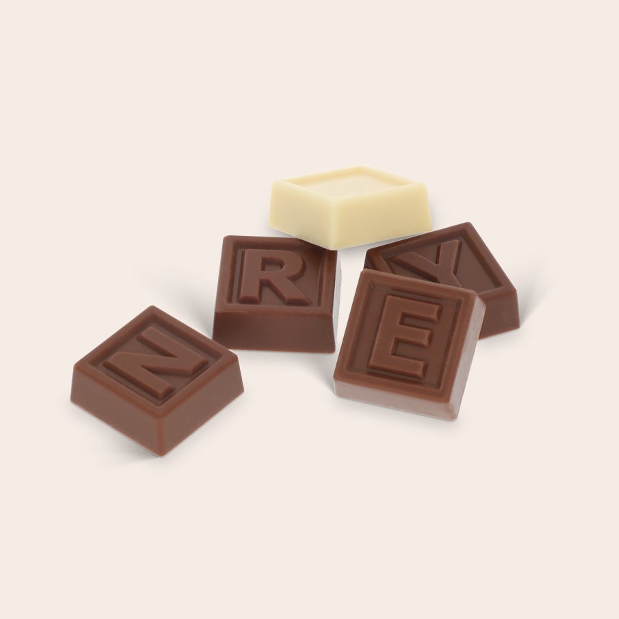 Personal chocolate telegram with milk chocolate letters N R E Y and one white chocolate block