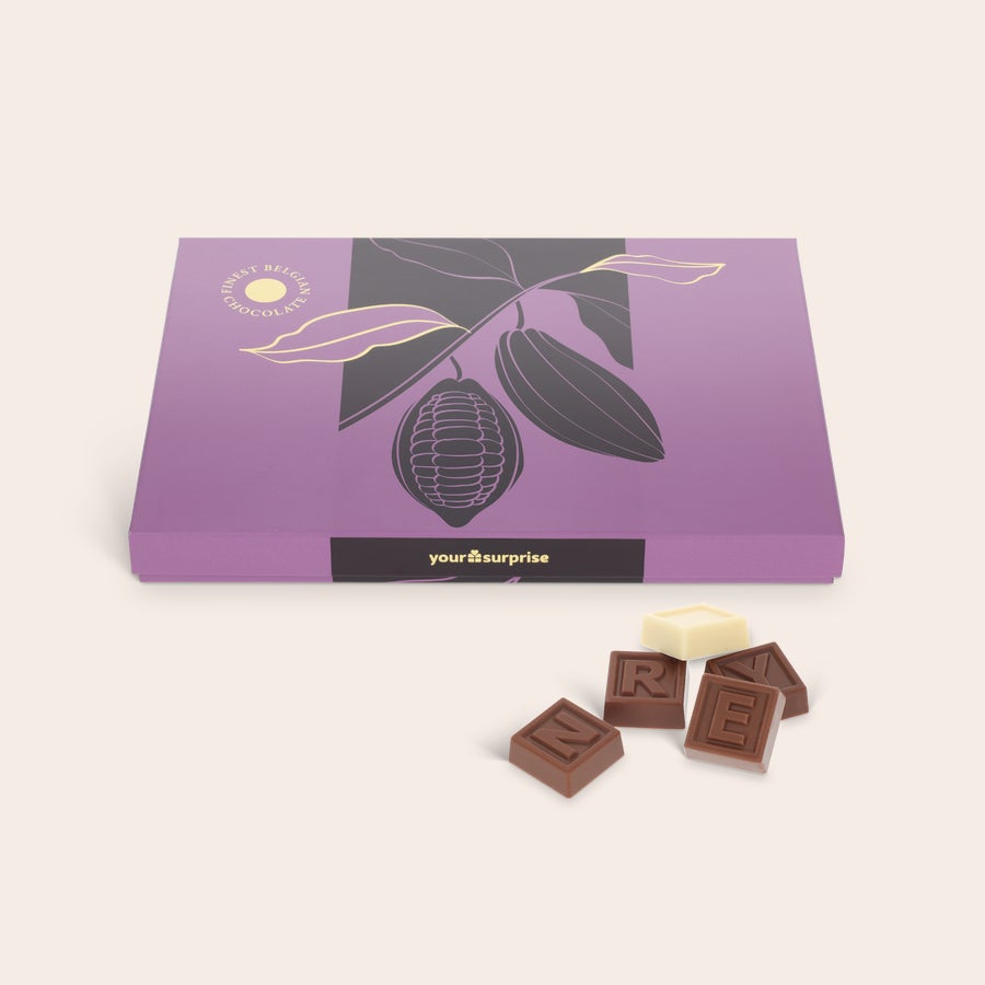 Personalised Chocolate Telegram A purple gift box with a cocoa tree design, next to custom milk and white chocolate letters for a personal chocolate telegram