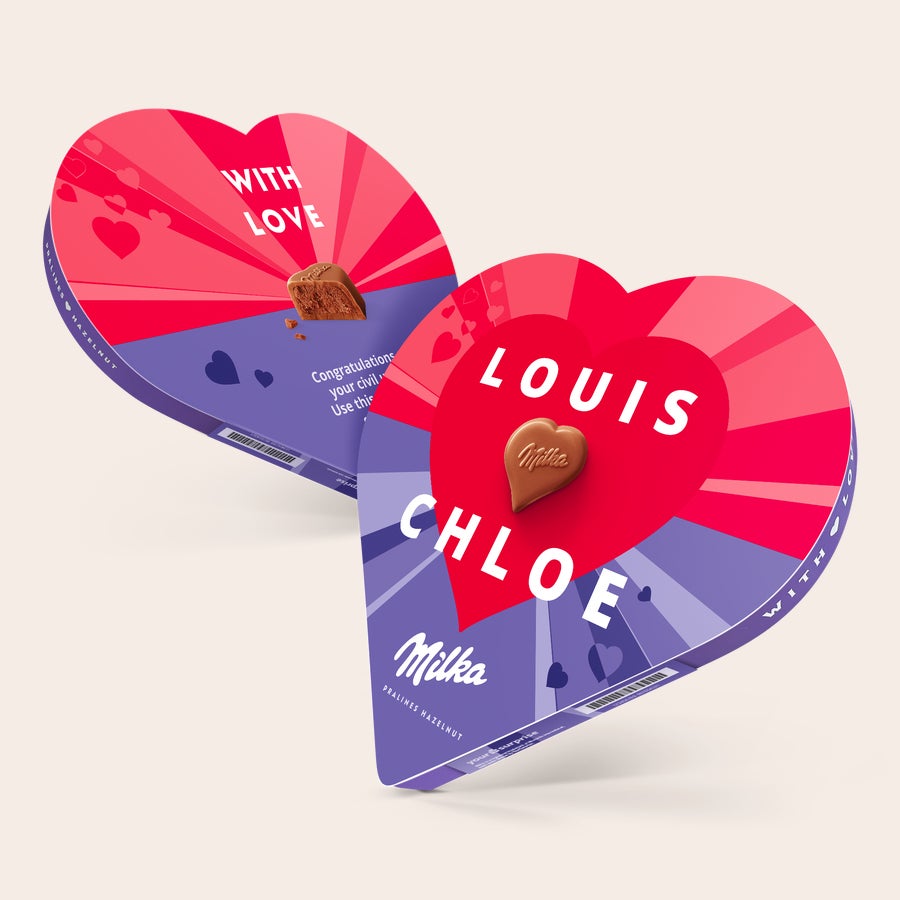 Milka chocolate heart Two personalized Milka heart chocolate boxes, one printed with "Louis" and "Chloe," the other with "With Love" and an open hazelnut praline.