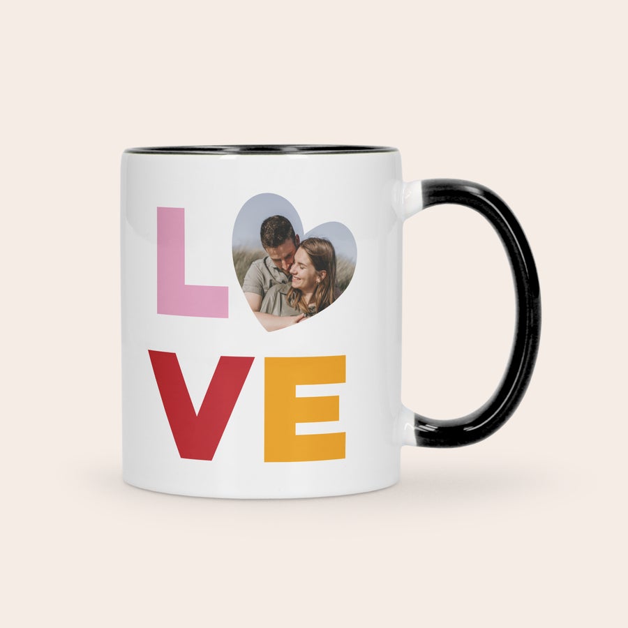 A white and black personalized coloured mug with a photo and the word LOVE printed on it as a gift
