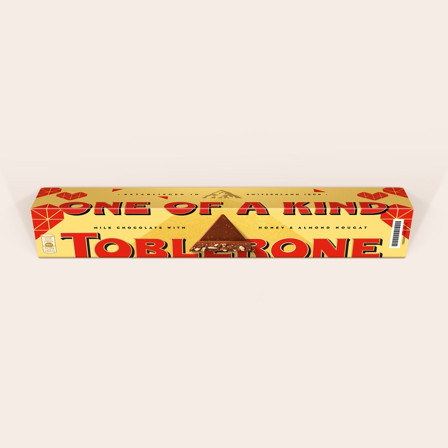 Personalised Toblerone Chocolate Bar - Love Toblerone bar with a custom wrapper printed with the phrase ONE OF A KIND and a visible chocolate piece