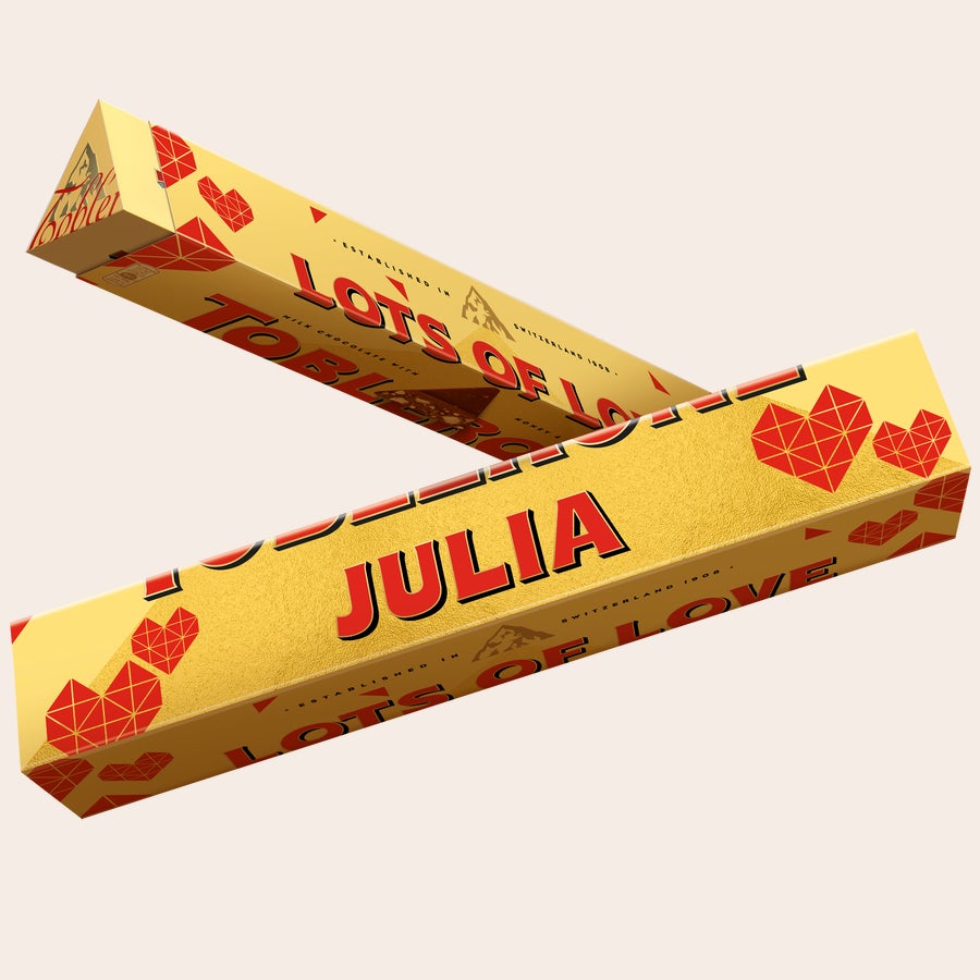 Personalised Toblerone Chocolate Bar - Love Personalized Toblerone bar with a name and photo, custom printed with "Julia" and "Lots of Love" on a yellow wrapper with red hearts.