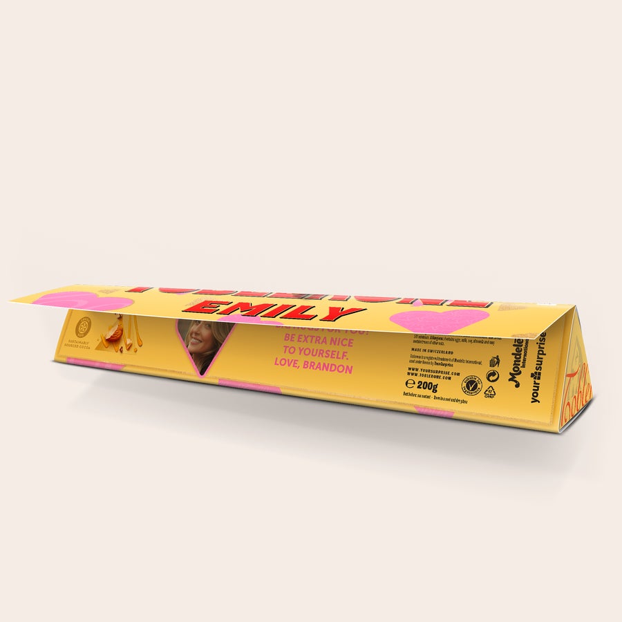 Personalised Toblerone Chocolate Bar - Love Personalized Toblerone bar printed with EMILY name and a photo of a woman, with text "BE EXTRA NICE TO YOURSELF. LOVE, BRANDON."