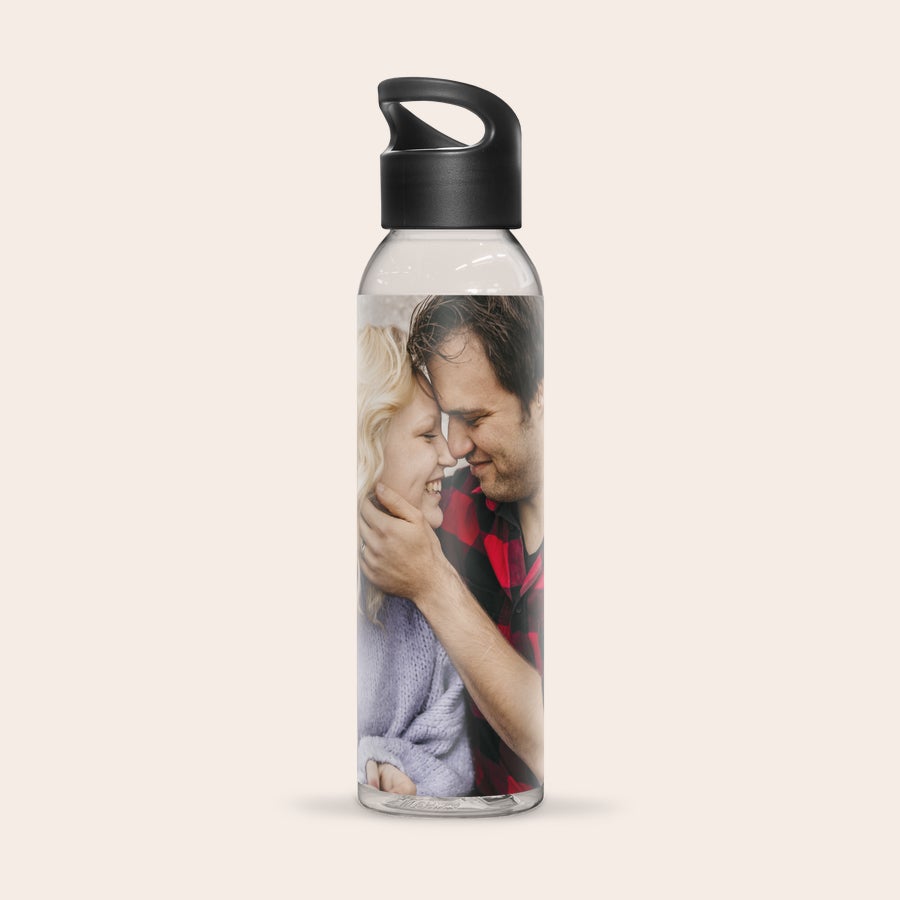 Personalized water bottle printed with a photo of a couple smiling.