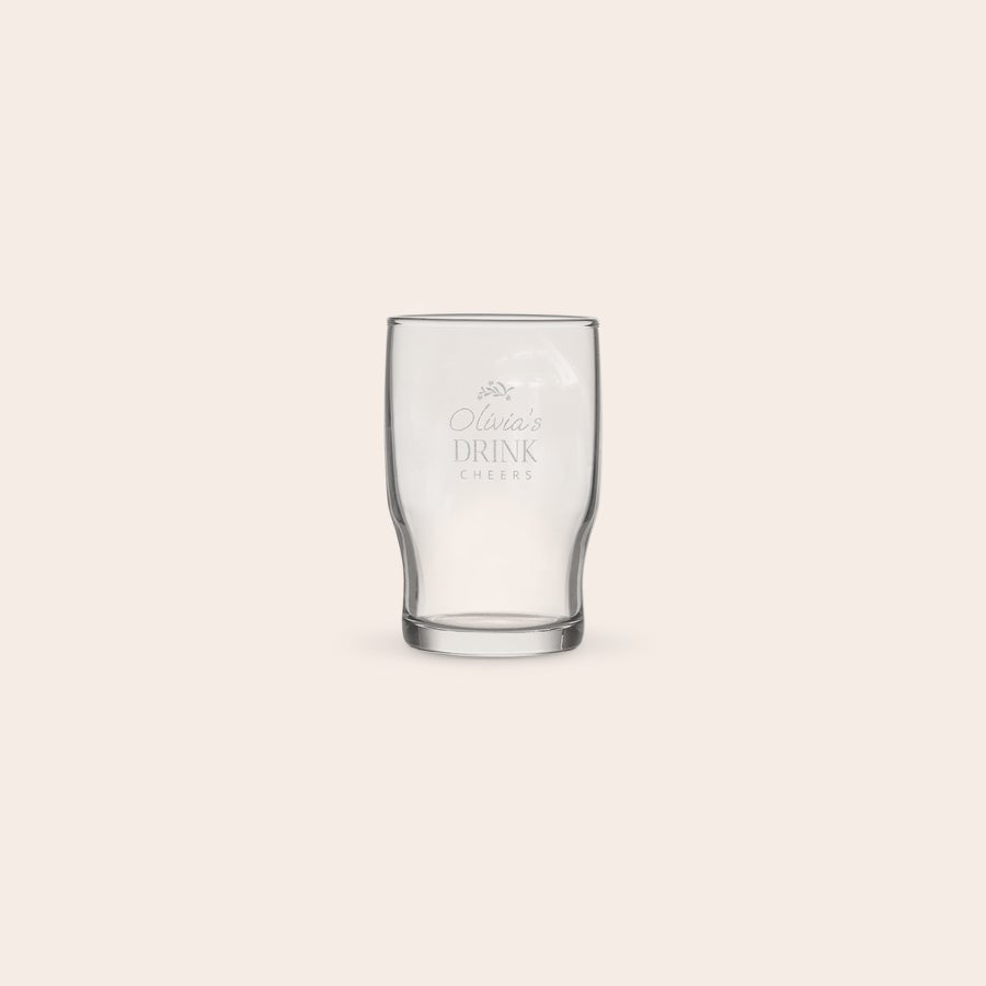 A personalized water glass engraved with "Olivia's Drink Cheers" for a refreshing beverage.