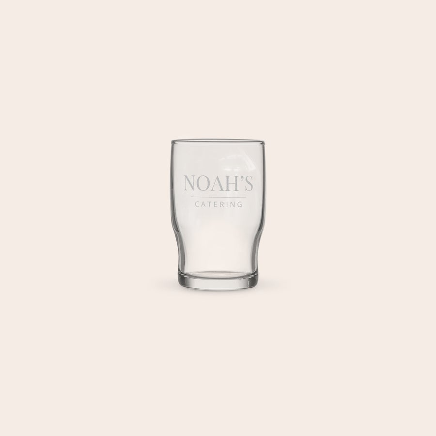 Personalised water glass A personalised water glass engraved with the text "NOAH'S CATERING" on the front